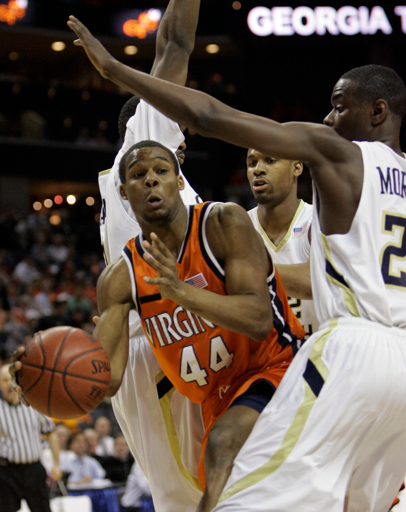 Virginia's Sean Singletary, center, looks to pass as Georgia Tech's Anthony Morrow, right, defends in the first half of an ACC men's basketball tournament game at Bobcats Arena in Charlotte, N.C., Thursday, March 13, 2008. (AP Photo/Gerry Broome)