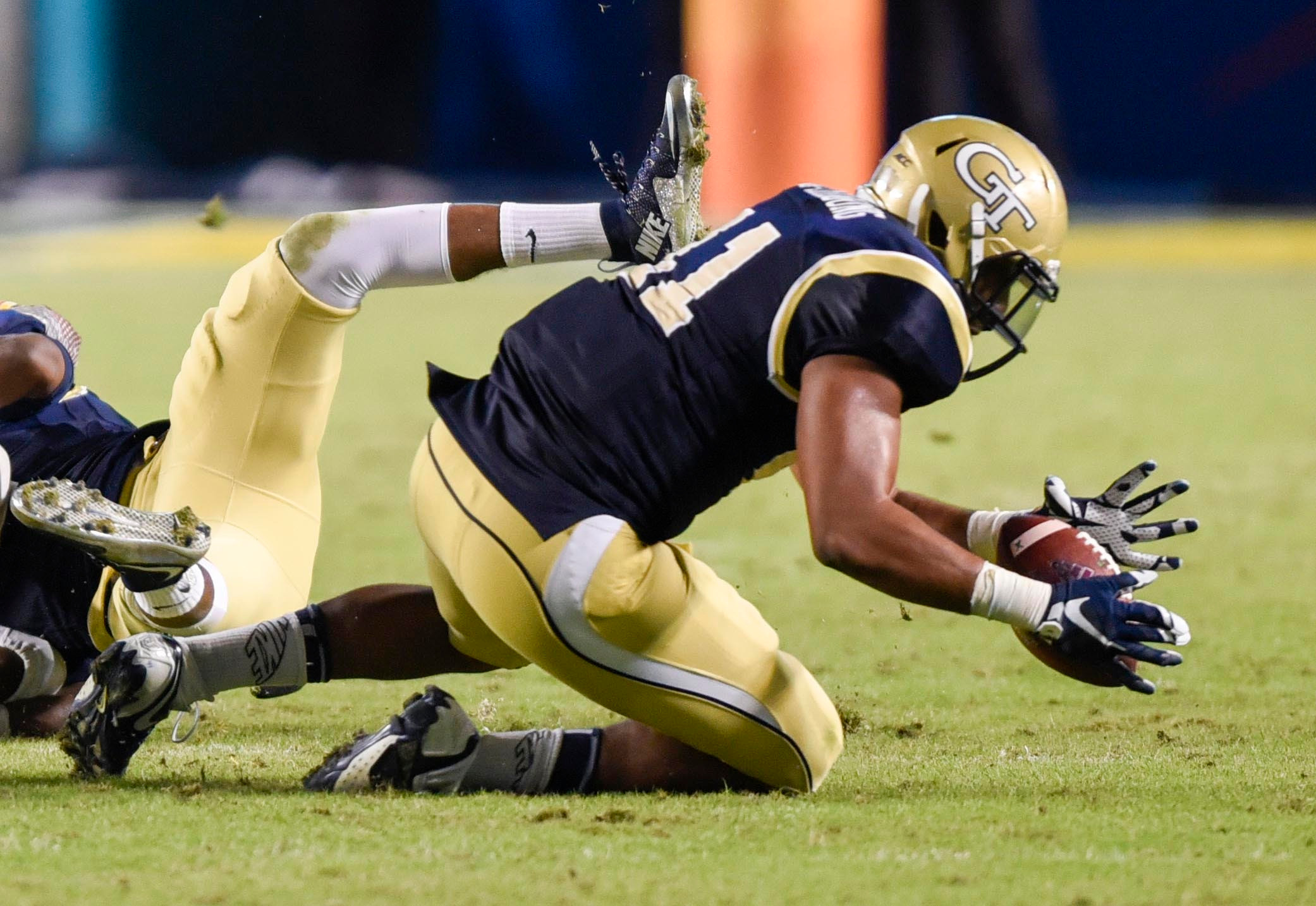 Dec 31, 2014; Miami Gardens, FL, USA; Georgia Tech Yellow Jackets defensive end Roderick Rook-Chungong (41) recovers a fumble against the Mississippi State Bulldogs in the second half of the Orange Bowl game at Sun Life Stadium. Mandatory Credit: Brad Barr-USA TODAY Sports