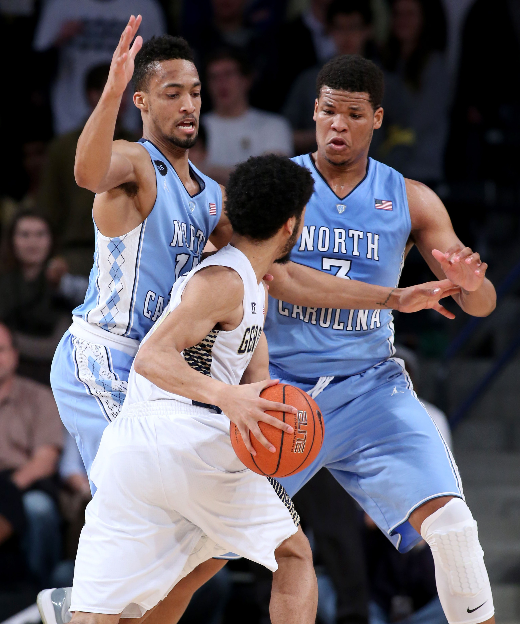 Georgia Tech Yellow Jackets guard Josh Heath (11) is defended by North Carolina Tar Heels forward J.P. Tokoto (13) and forward Kennedy Meeks (3) in the first half of their game at McCamish Pavilion. The Tar Heels won 81-49. Jason Getz-USA TODAY Sports