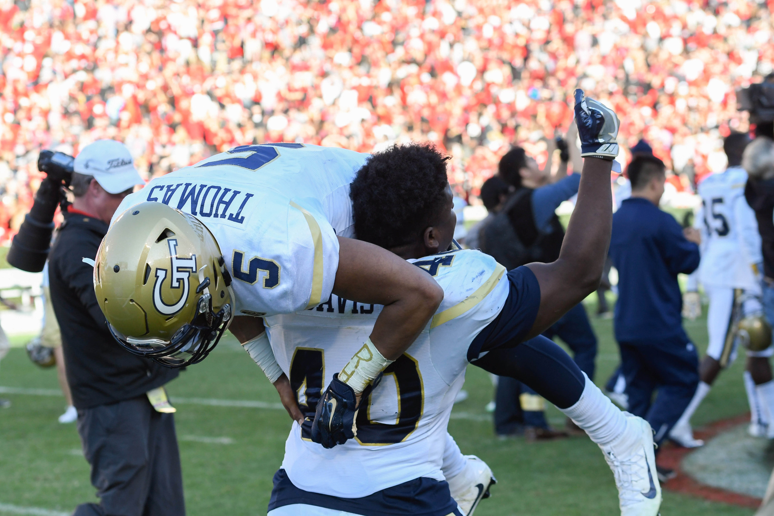 Yellow Jackets linebacker P.J. Davis (40) carries quarterback Justin Thomas (5) around the field after defeating the Georgia Bulldogs at Sanford Stadium. Dale Zanine-USA TODAY Sports