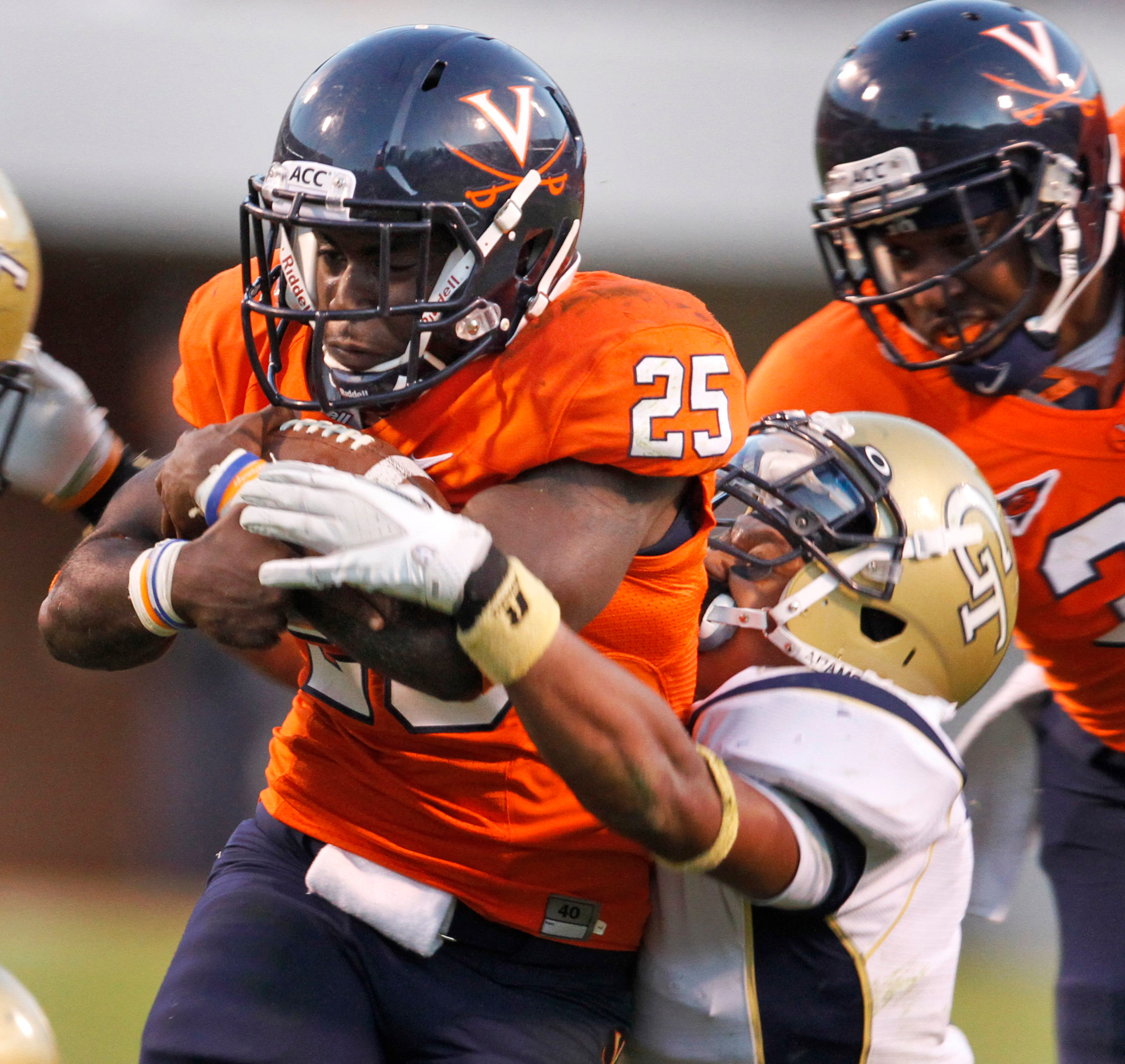 Georgia Tech safety Isaiah Johnson (1) tries to pull down Virginia running back Kevin Parks. (AP Photo/Steve Helber)