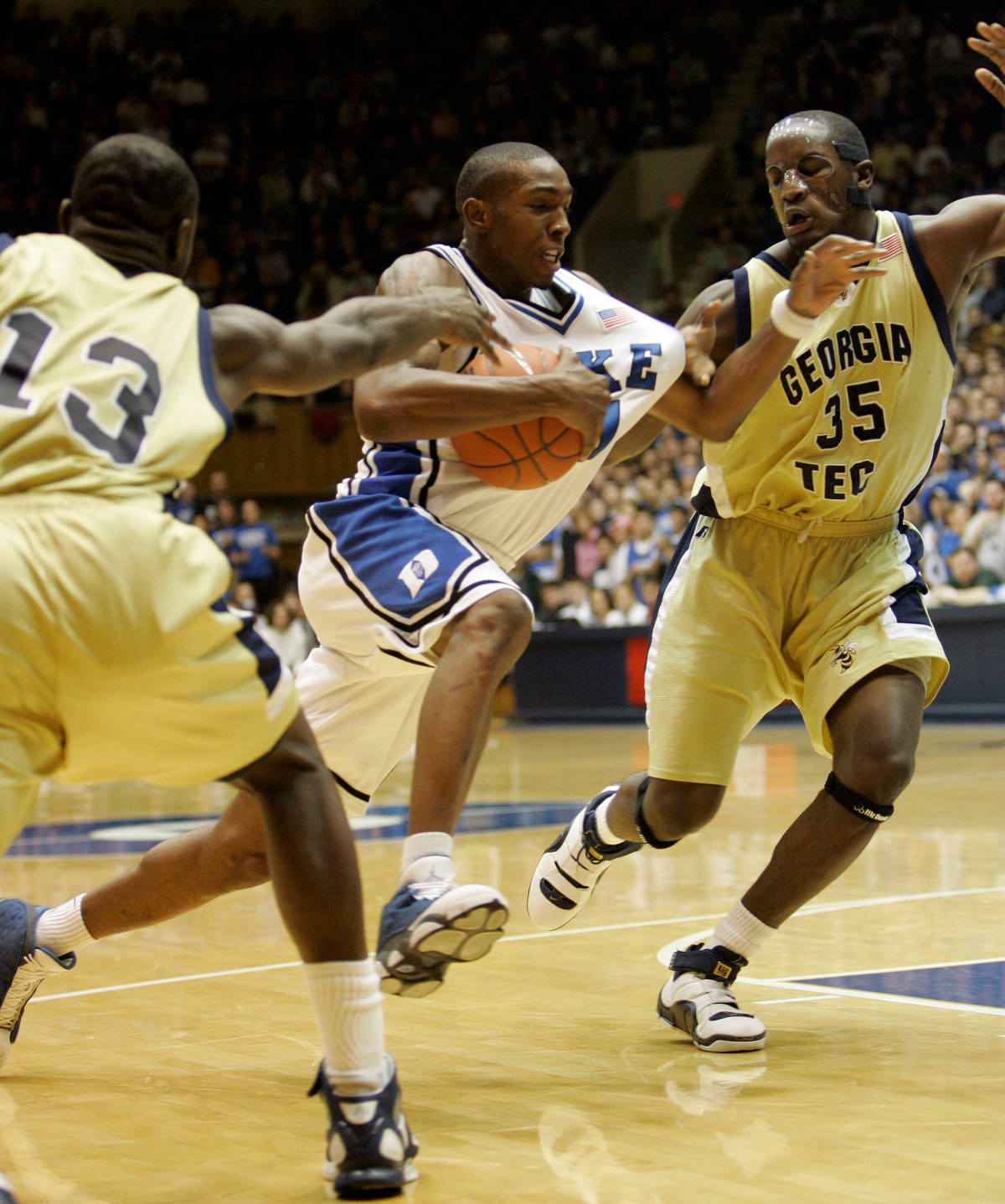 Duke's DeMarcus Nelson, center, drives between Georgia Tech's D'Andre Bell (13) and Zach Peacock (35) during the first half of a college basketball game in Durham, N.C., Sunday, Feb. 18, 2007. (AP Photo/Gerry Broome)