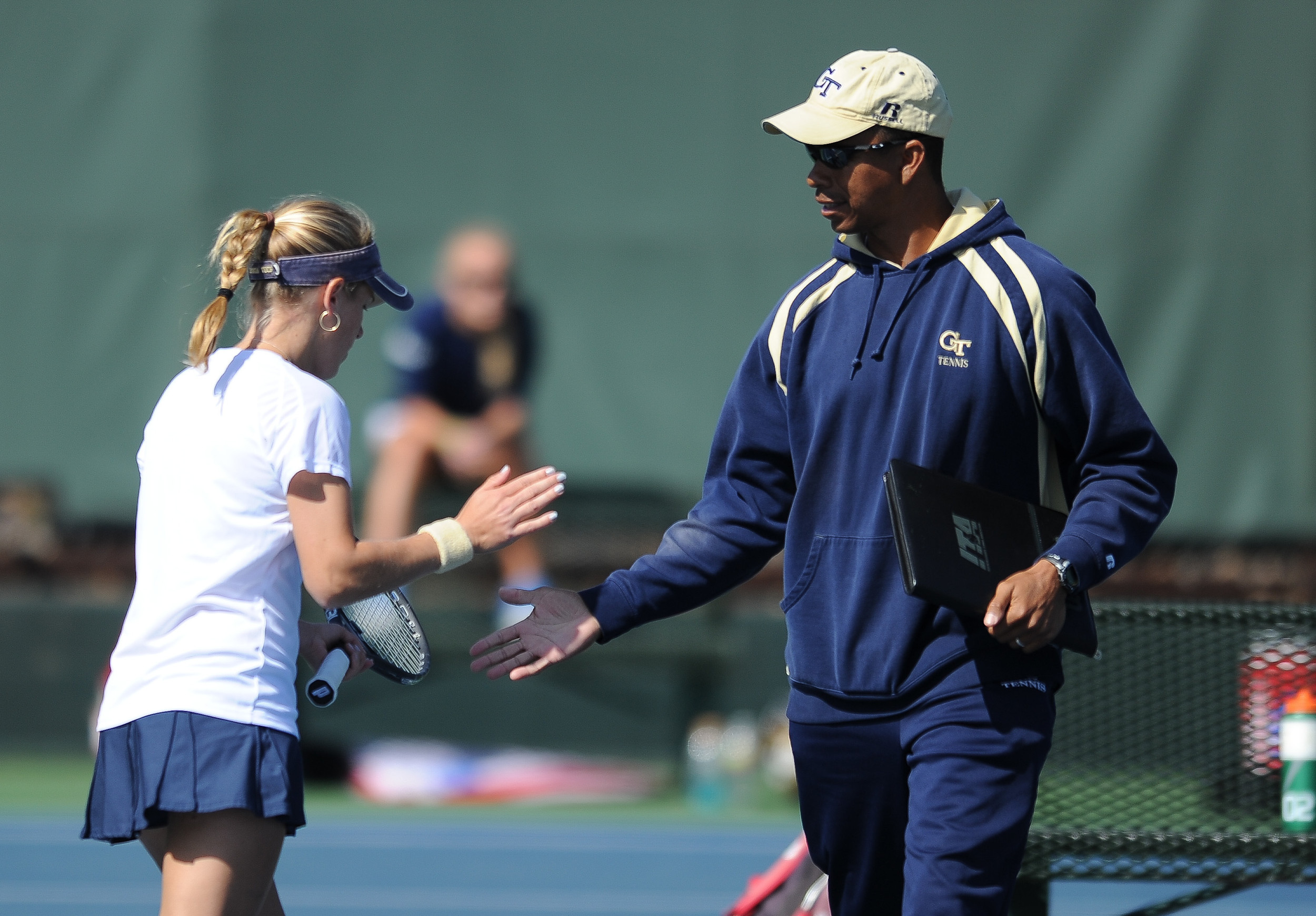 Head Coach Bryan Shelton congratulates Lynn Blau after her singles victory against Duke in the NCAA Tournament.