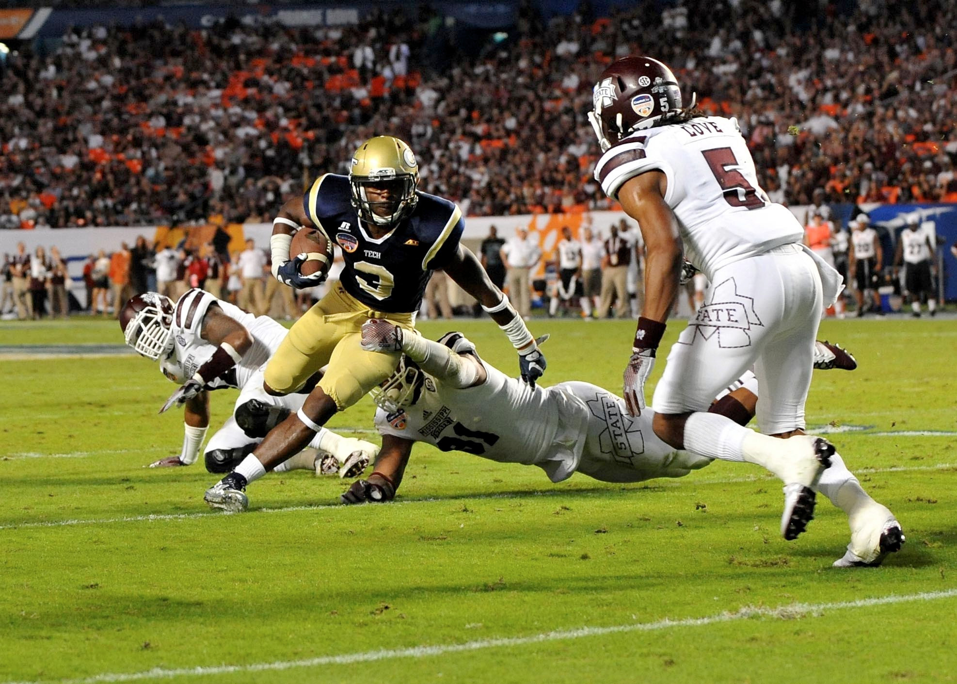 Dec 31, 2014; Miami Gardens, FL, USA; Georgia Tech Yellow Jackets quarterback Justin Thomas (5) is tackled by Mississippi State Bulldogs defensive back Tolando Cleveland (31) during the second quarter in the 2014 Orange Bowl at Sun Life Stadium. Mandatory Credit: Steve Mitchell-USA TODAY Sports