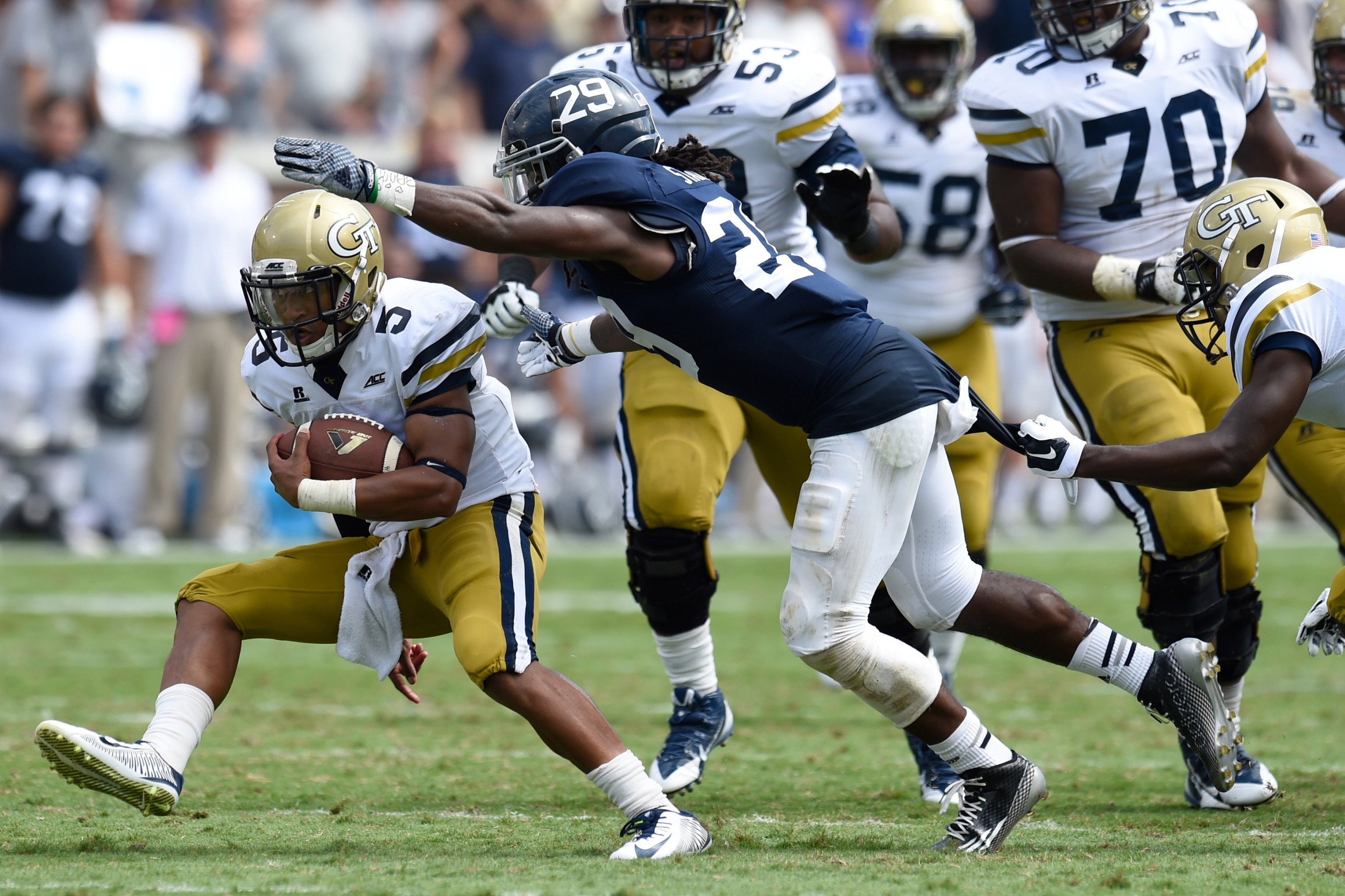 Sep 13, 2014; Atlanta, GA, USA; Yellow Jackets quarterback Justin Thomas (5) runs past Georgia Southern Eagles safety Deion Stanley (29) during the second half. Dale Zanine-USA TODAY Sports