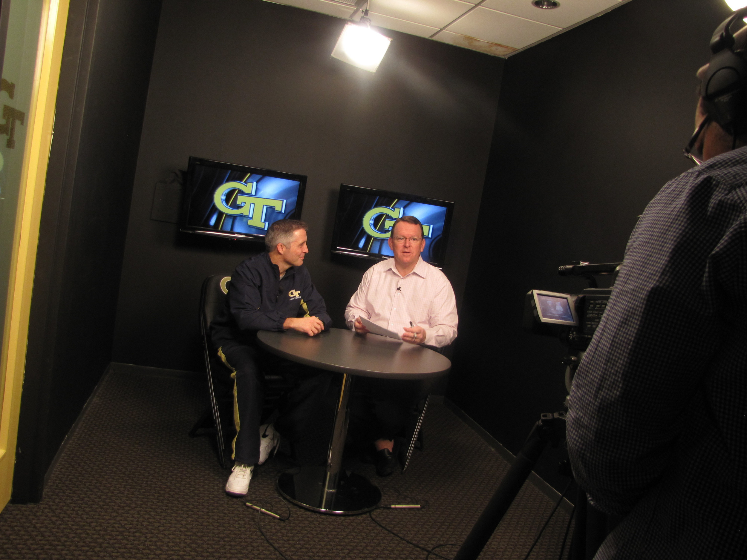 Coach Brian Gregory and Wes Durham tape three segments of his TV show.