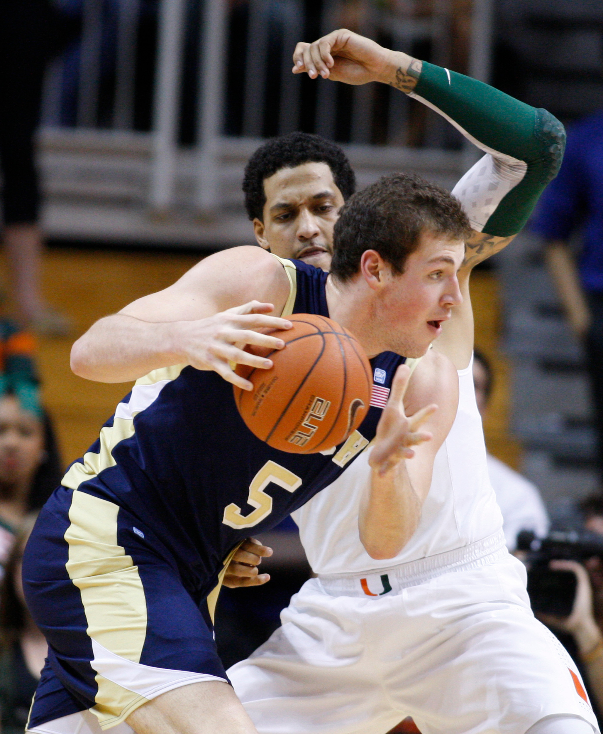 Georgia Tech's Daniel Miller (5) drives the ball on Miami's Julian Gamble. (AP Photo/Luis M. Alvarez)