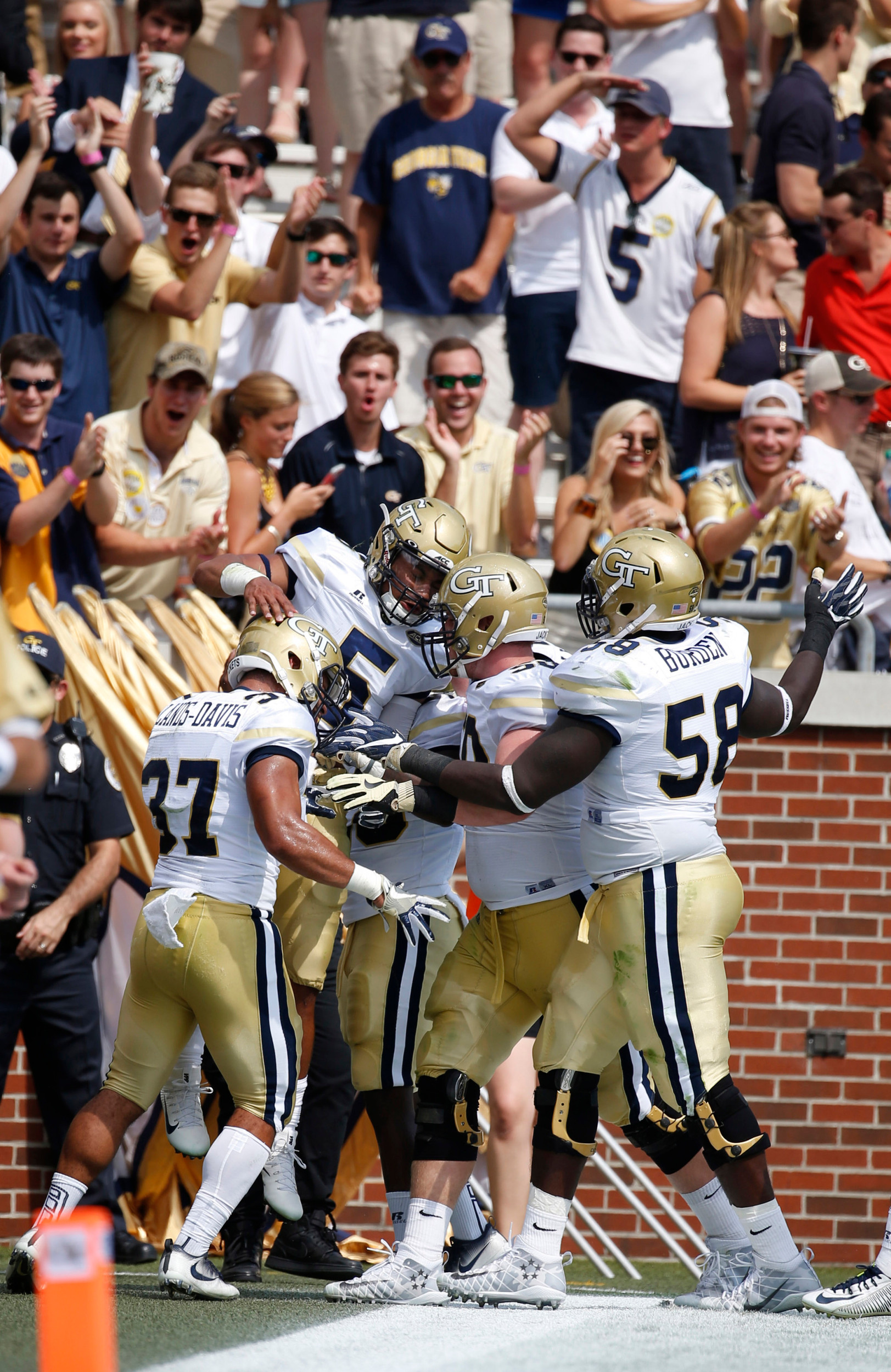 Georgia Tech quarterback Justin Thomas (5) celebrates his touchdown run with teammates. Jason Getz-USA TODAY Sports
