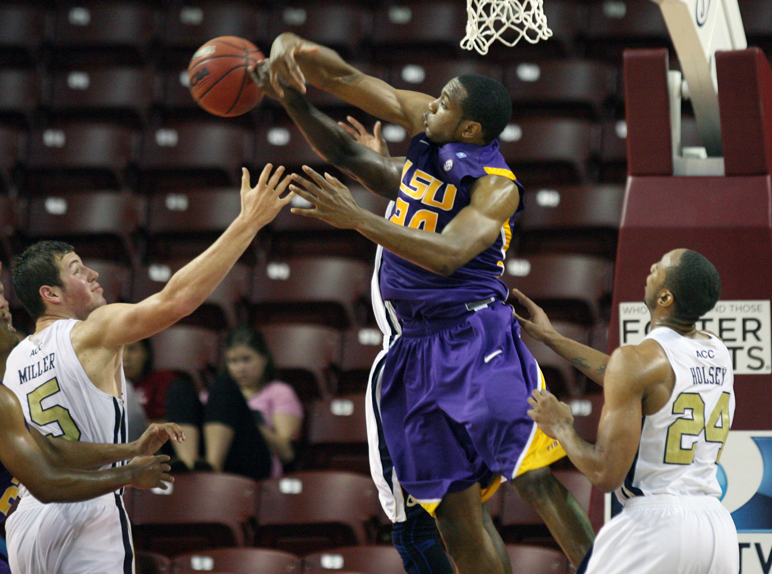 LSU's Storm Warren, center, fights for control of the ball against Georgia Tech's Daniel Miller, at left, and Kammeon Holsey, at right. (AP Photo/Mic Smith)