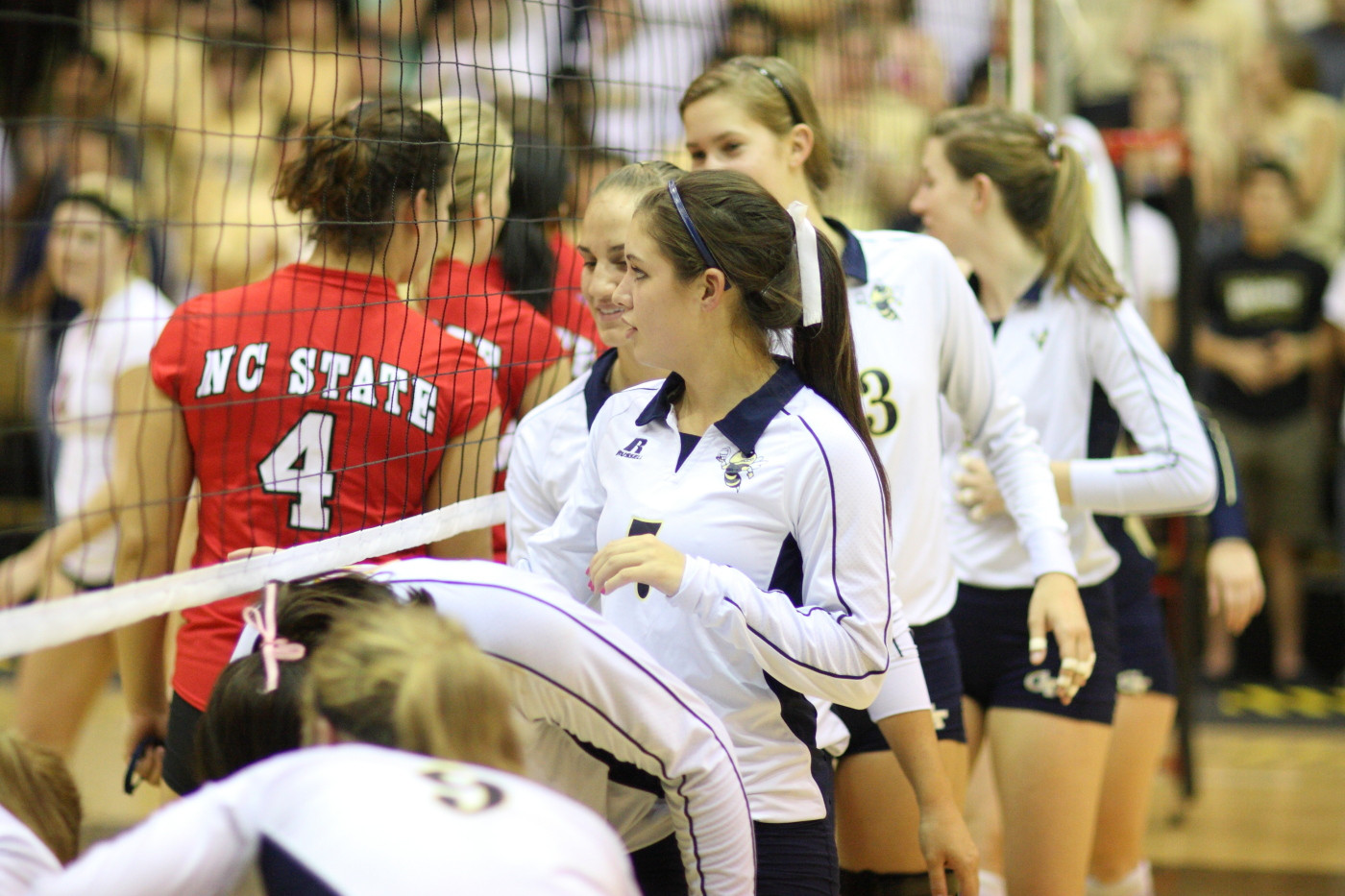 The Yellow Jackets shake hands with the Wolfpack