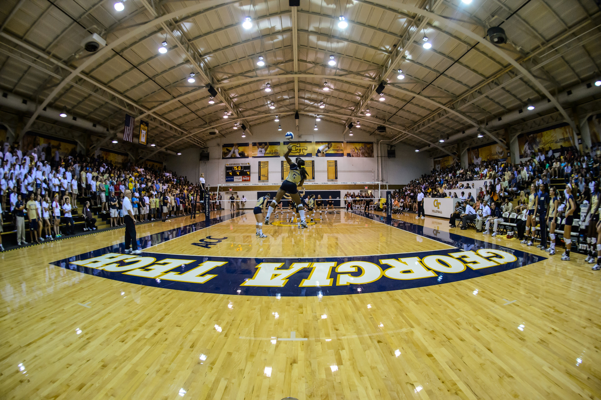 Monique Mead (5) serves in a crowded O'Keefe Gym