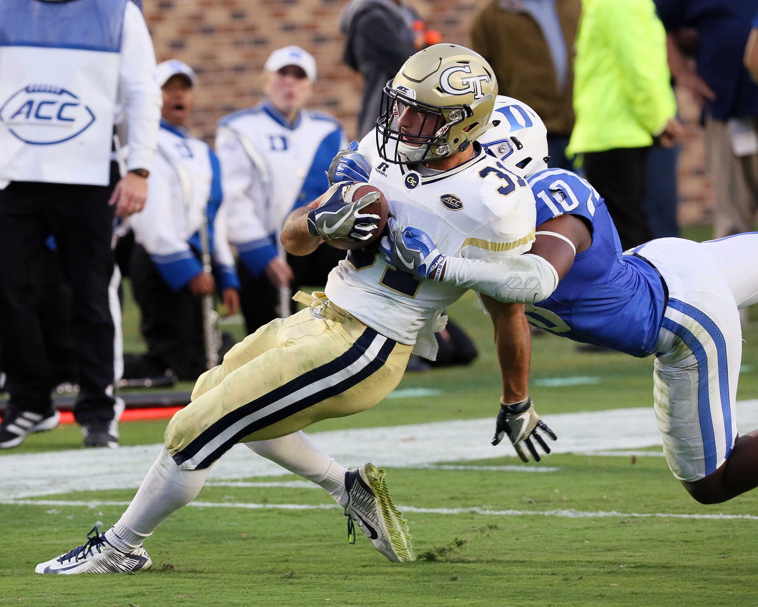 Nov 18, 2017; Durham, NC, USA; Georgia Tech Yellow Jackets running back Nathan Cottrell (31) gets tackled by Duke Blue Devils safety Marquis Waters (10) in the first half at Wallace Wade Stadium. Mandatory Credit: Mark Dolejs-USA TODAY Sports