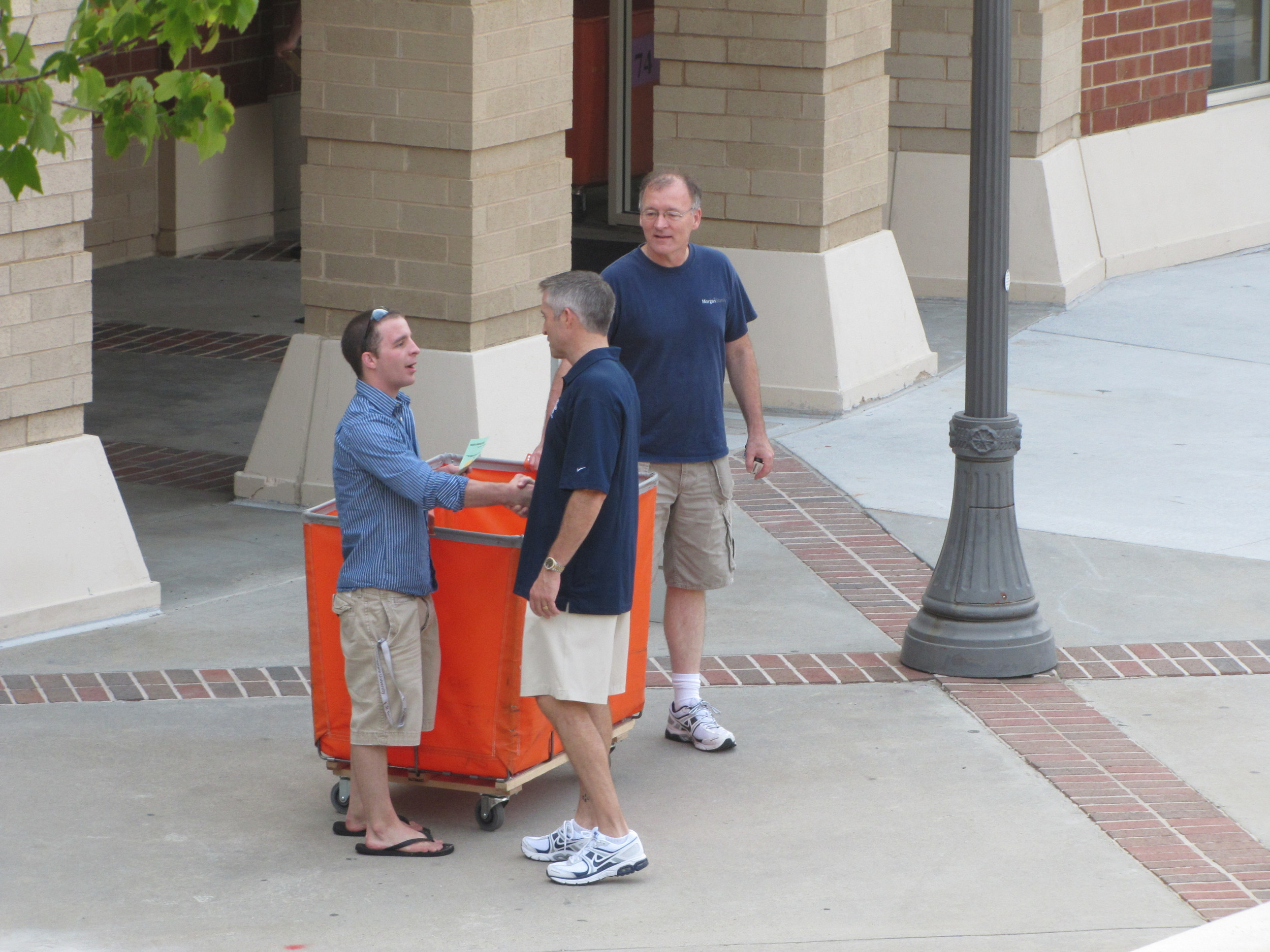 Brian Gregory greeting students at the North Avenue Apartments.