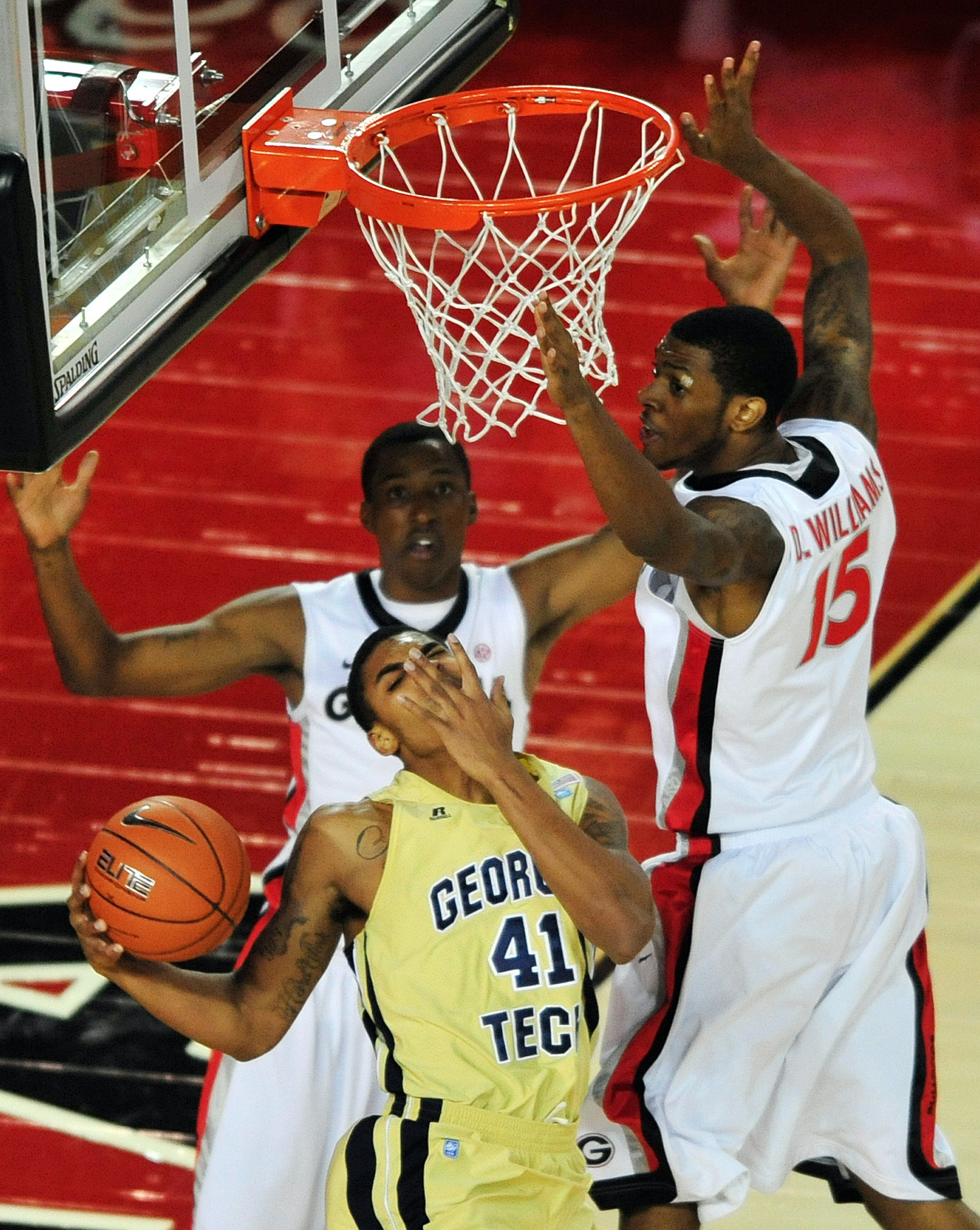 Georgia Tech's Glen Rice Jr. (41) grabs his face after being fouled by Georgia forward Donte Williams (15) during an NCAA college basketball game, Wednesday, Dec. 7, 2011, in Athens, Ga. (AP Photo/The Athens Banner-Herald, Richard Hamm) MAGS OUT; MANDATORY CREDIT; NO SALES; TV OUT