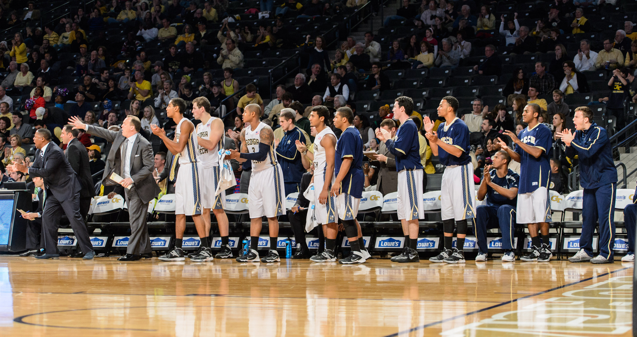 The bench reacts to Trae Golden's score.