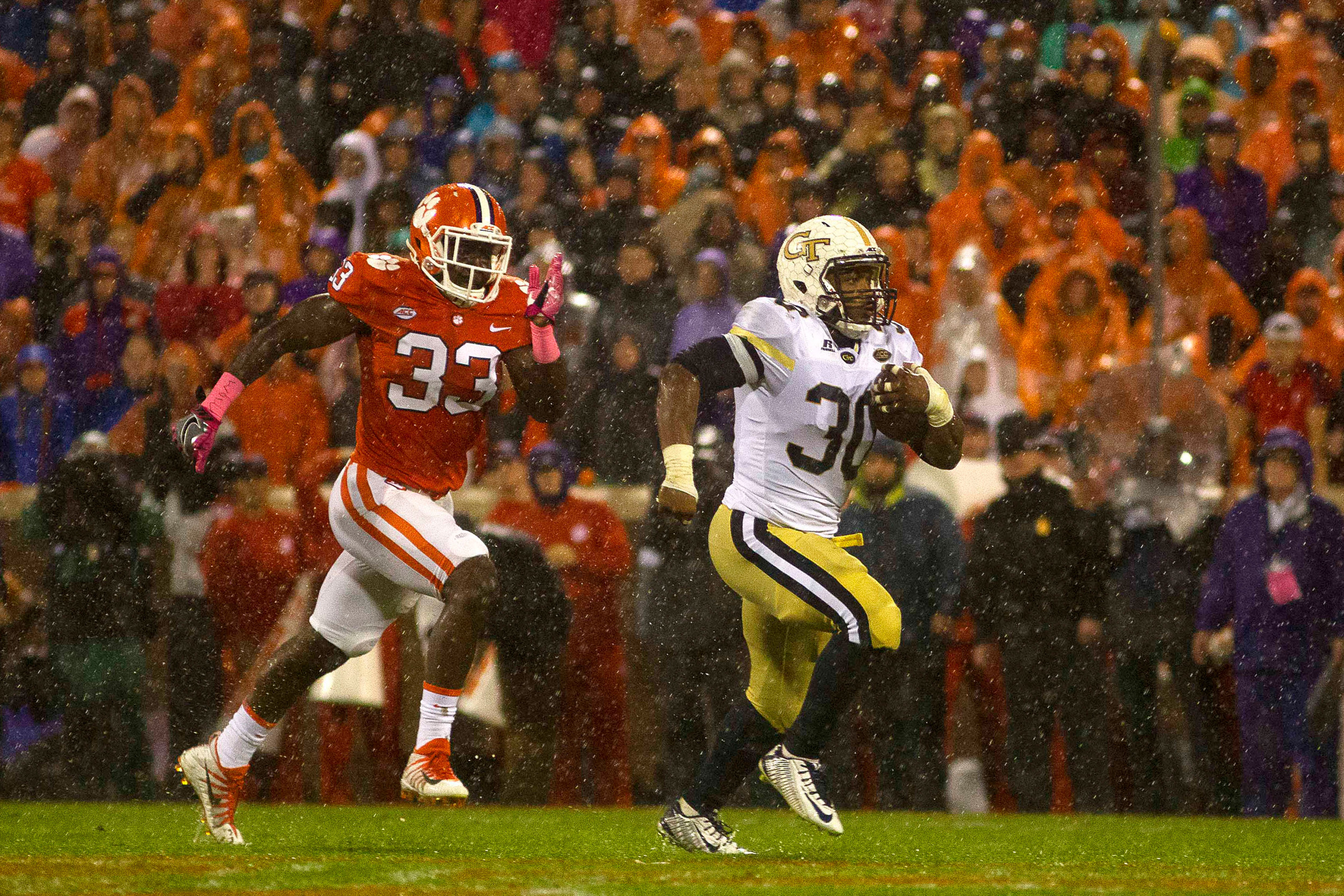 Oct 28, 2017; Clemson, SC, USA; Georgia Tech Yellow Jackets running back KirVonte Benson (30) carries the ball while being defended by Clemson Tigers linebacker J.D. Davis (33) during the first half at Clemson Memorial Stadium. Mandatory Credit: Joshua S. Kelly-USA TODAY Sports