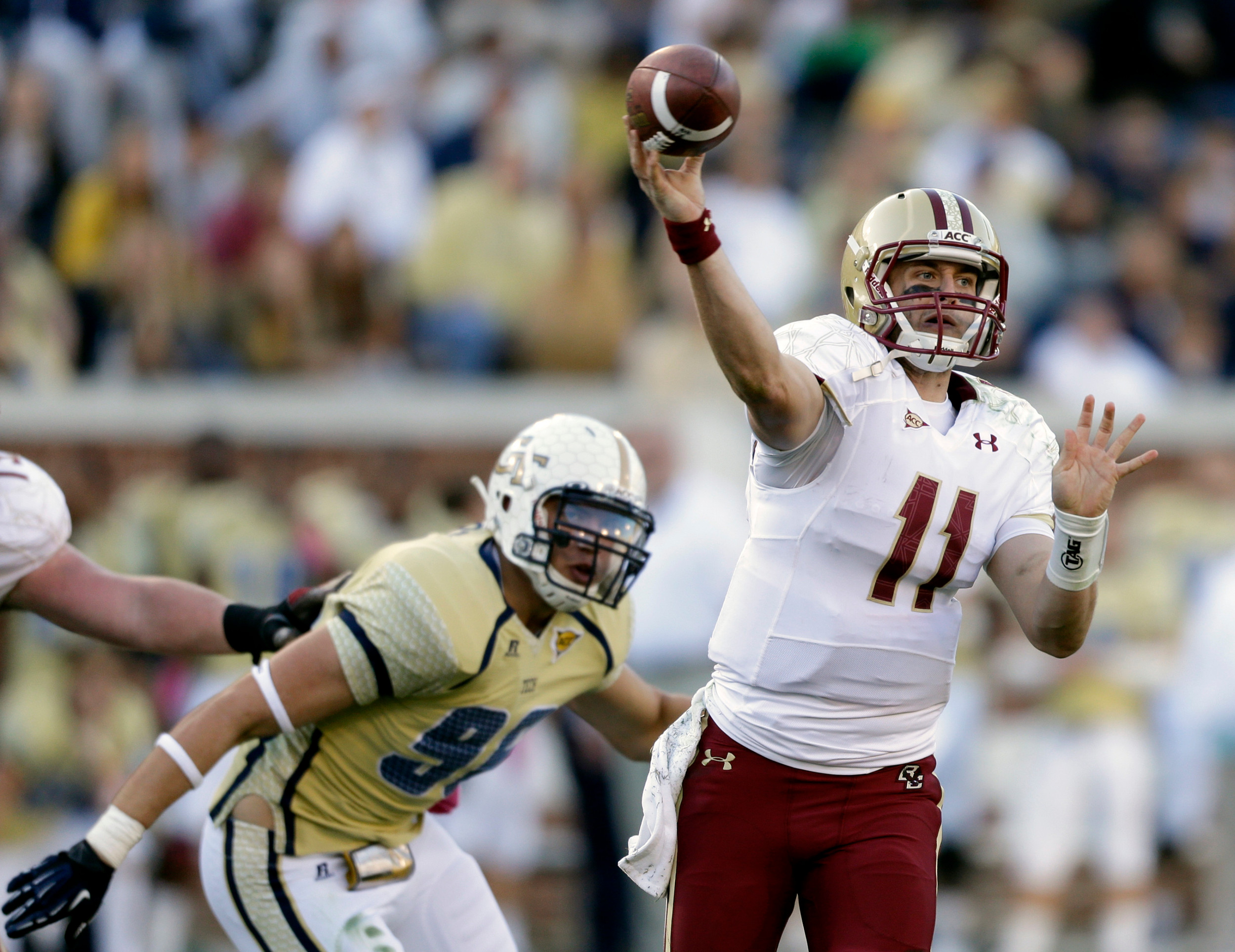 Boston College quarterback Chase Rettig, right, throws an incomplete pass as Georgia Tech defensive lineman Adam Gotsis, rear, looks on during the fourth quarter. Georgia Tech won 37-17. (AP Photo/David Goldman)