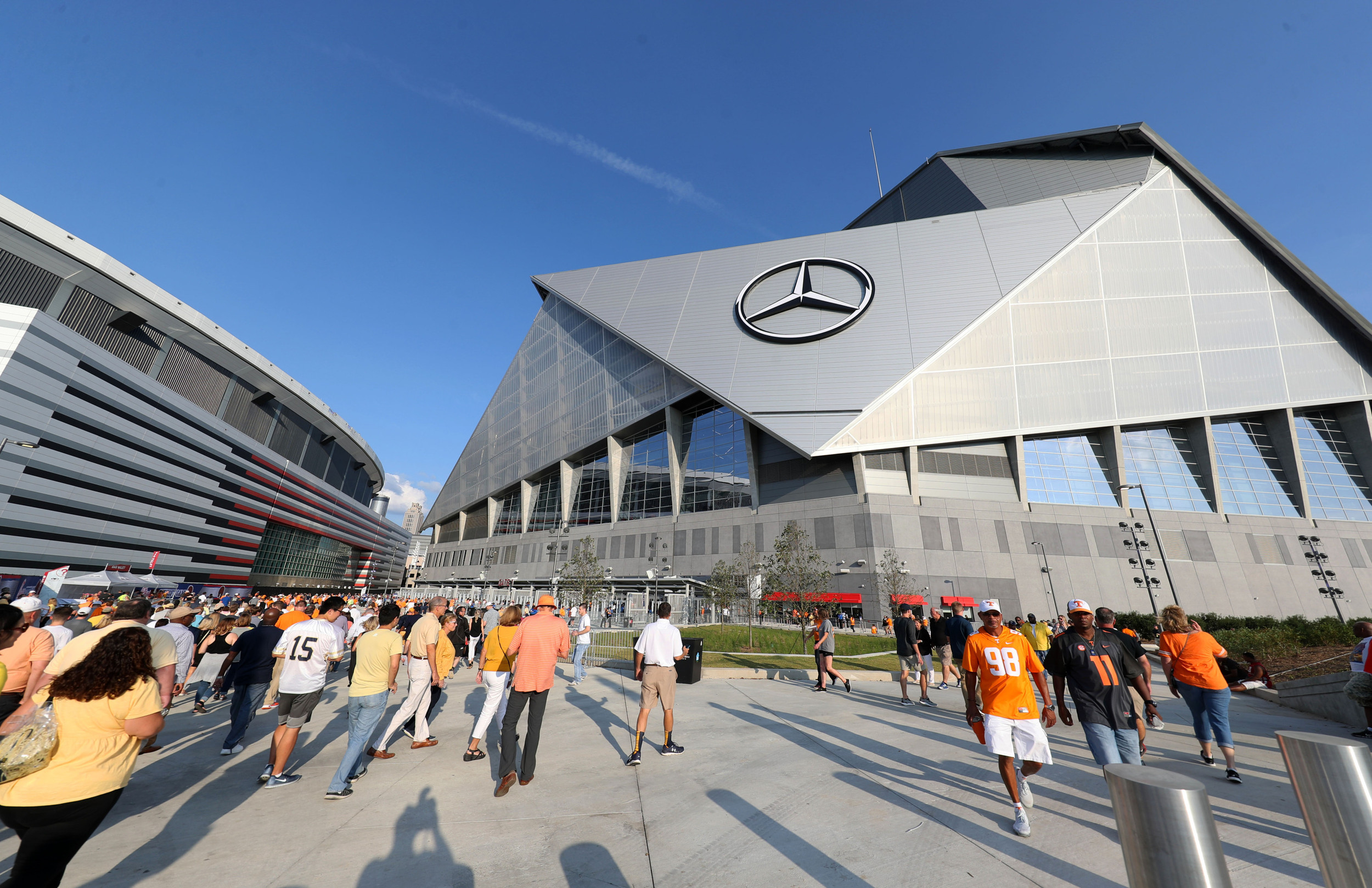 Sep 4, 2017; Atlanta, GA, USA; Fans walk between the old Georgia Dome (left) and Mercedes-Benz Stadium before a game between the Georgia Tech Yellow Jackets and the Tennessee Volunteers. Mandatory Credit: Jason Getz-USA TODAY Sports
