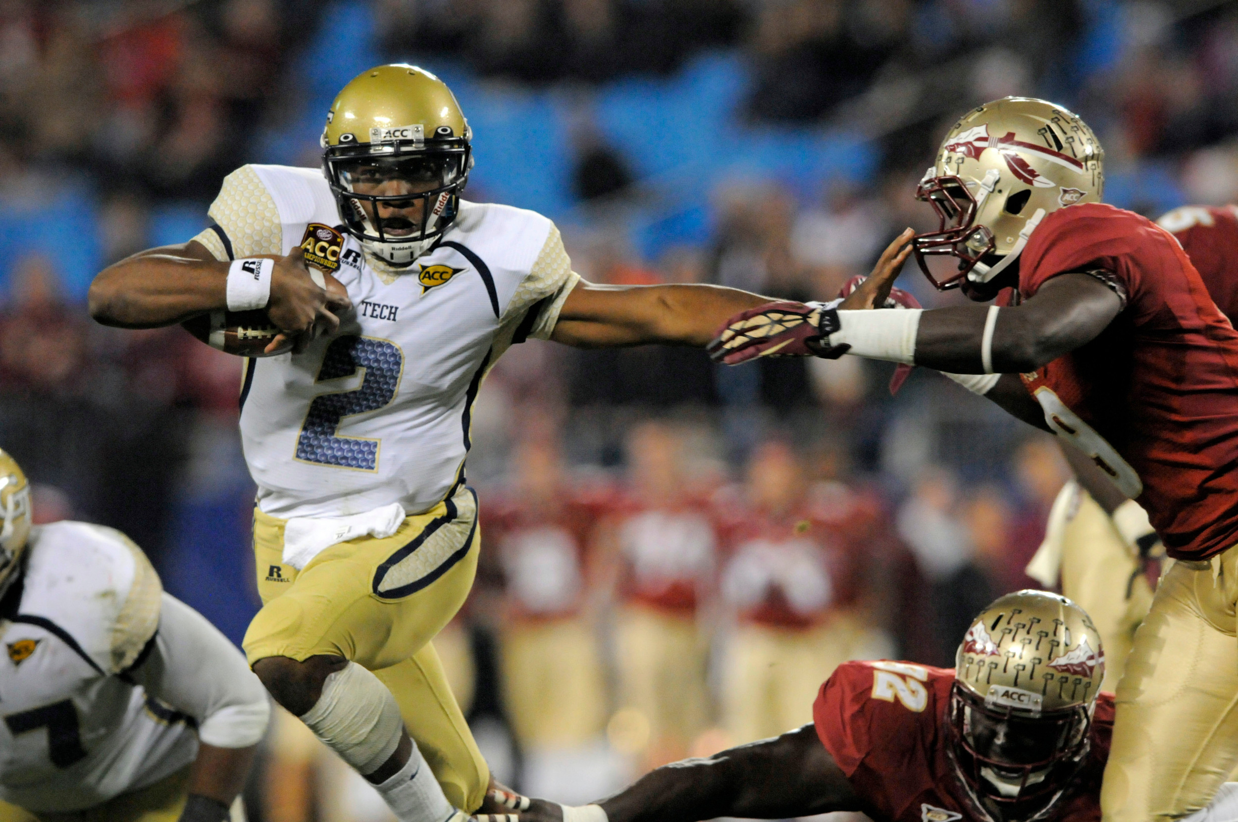 Georgia Tech's Vad Lee (2) tries to run past Florida State's Timmy Jernigan (8) during the first half. (AP Photo/Mike McCarn)